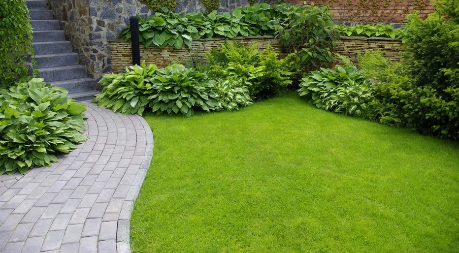 Landscaped front steps with flowers, shrubs, stone edging, and fresh mulch